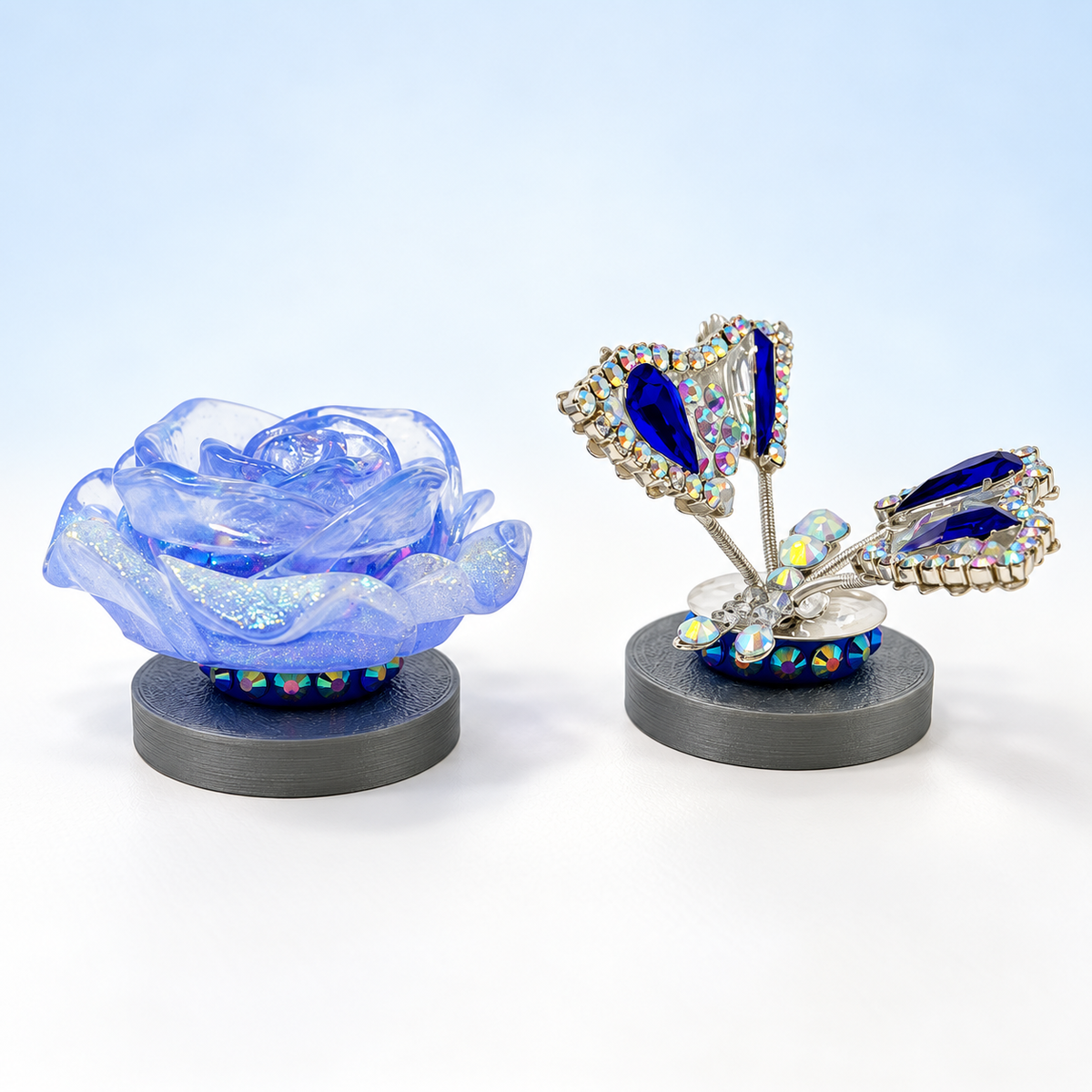 Blue glitter resin rose and navy rhinestone butterfly on silver character stands
