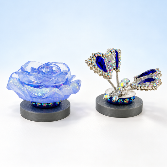Blue glitter resin rose and navy rhinestone butterfly on silver character stands