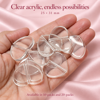Close-up of clear 25 × 31 mm acrylic heart plate base beads with central through-holes, shown in a hand.